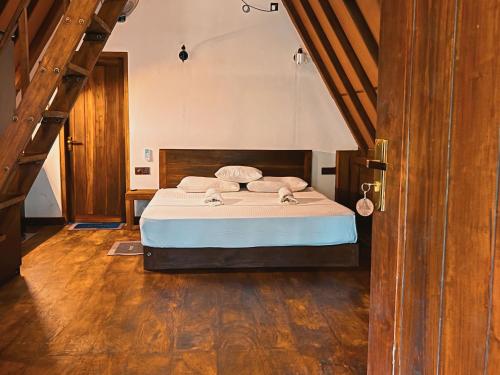 a bedroom with a bed and a wooden floor at Eco Breath Cabana in Sigiriya