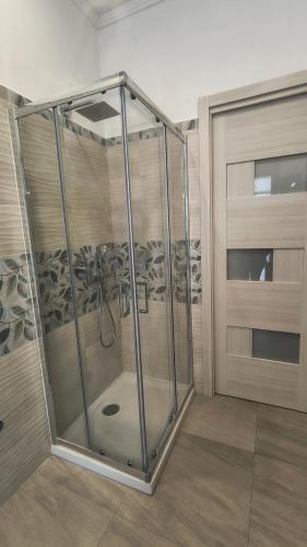a shower in a room next to a door at Casa Michela in Sant'Agnello