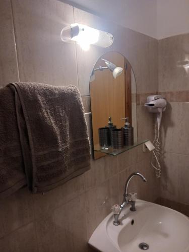 a bathroom with a sink and a mirror at Anastasios Room's in Olympic Beach