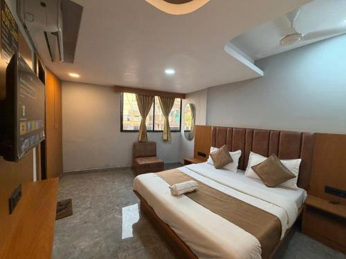 a bedroom with a large bed in a room at Hotel Sun Lake in Ahmedabad