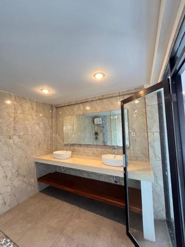 a bathroom with two sinks and a mirror at Serenity Nirvana Palace Jimbaran - Near Uluwatu in Jimbaran