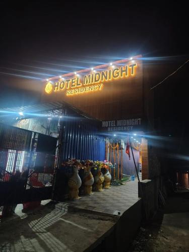 a hotel midnightestation sign in front of a building at Hotel Midnight in Muzaffarpur