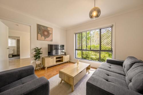 a living room with a couch and a table at 3BR Coomera Duplex 2- Cute & Cosy Home Close to Theme Park in Gold Coast
