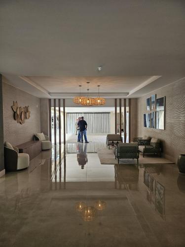 a man walking through a living room in a house at Prainha Sand Beach Arraial do Cabo in Arraial do Cabo