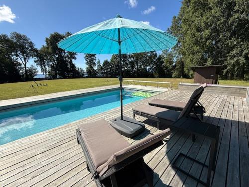 a patio with a chair and an umbrella next to a pool at Rukachohan in Pucón