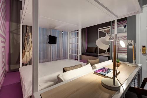 a living room with a bed and a table at Colors Urban Hotel Thessaloniki in Thessaloniki