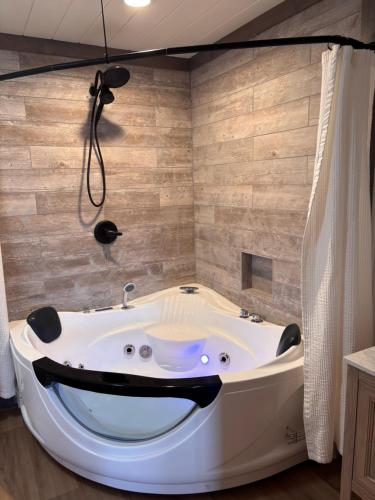 a bath tub in a bathroom with a face painted on the wall at Classy Bear Cabin - Summit Views of Ober Mountain, Hot Tub, 3 King Beds, 2 Mi to Downtown in Gatlinburg