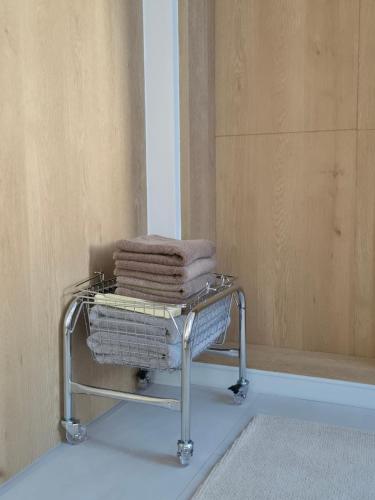 a towel rack with towels on it in a bathroom at 로프트부산 loft busan in Samgong