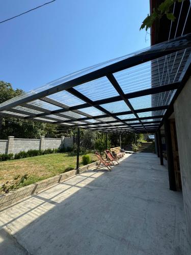 awning over a patio with picnic tables under it at Nebi Winery in Chʼardakhi