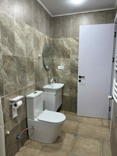 a bathroom with a toilet and a sink at Nebi Winery in Chʼardakhi
