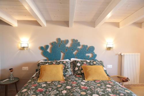 a bedroom with a bed with a cactus mural on the wall at Lo splendore dei Sassi in Matera