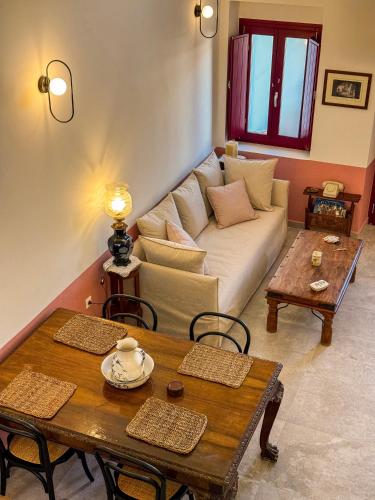 a living room with a couch and a table at Arbarorisa Traditional Suites in Mesaria