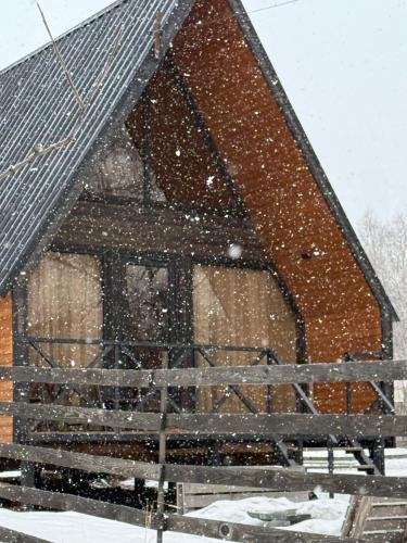a house covered in snow in front at Forest view kazbegi in Sioni
