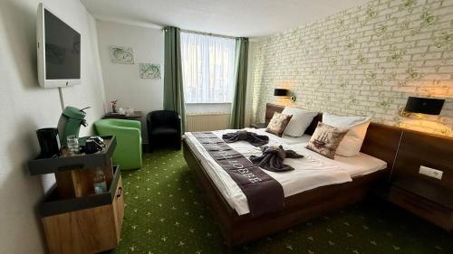 a hotel room with a bed with towels on it at Strand-Hotel Lobbe in Lobbe