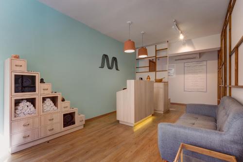 a living room with a couch and a table at Colors Urban Hotel Thessaloniki in Thessaloniki
