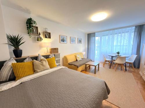 a bedroom with a bed and a living room at Wohlfühl Apartment Bad Reichenhall nahe Salzburg in Bad Reichenhall