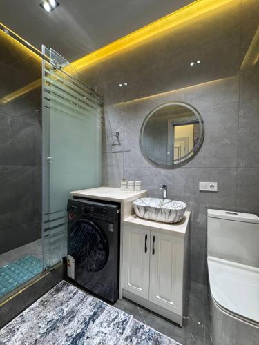 a bathroom with a sink and a washing machine at White Guest House in Samarkand