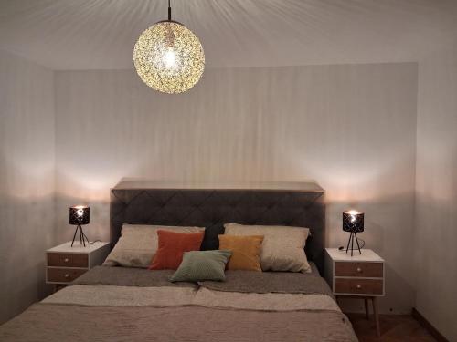 a bedroom with a large bed with two night stands at Apartment Andreja Bled in Bled