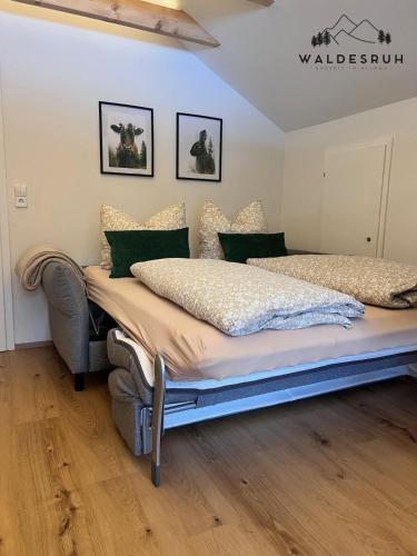 a bedroom with a large bed in a room at Waldesruh in Grünenbach