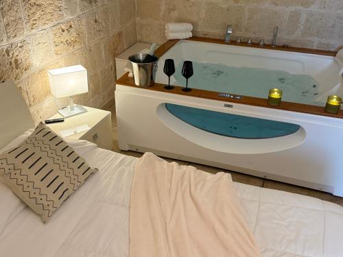 a bathroom with a bath tub and a sink at La Suite in Centro con vasca idromassaggio - Relax & Spa in Bari
