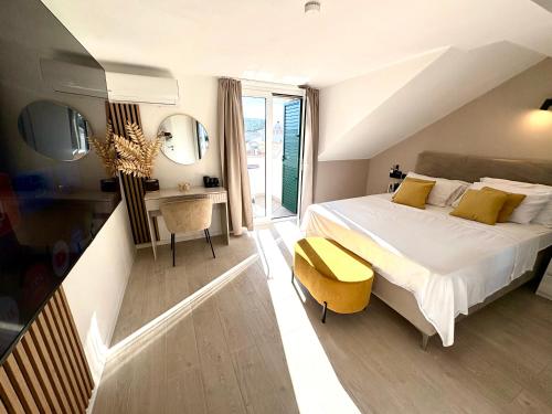 a bedroom with a bed and a desk and mirror at Apartment Anchor Luxury in Slatine