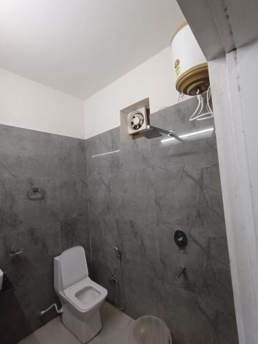 a bathroom with a toilet and a shower at Prince Vatika in Alwar