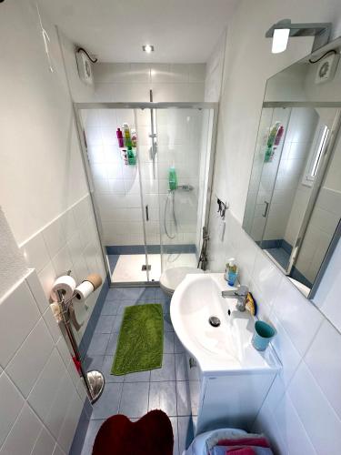 a white bathroom with a shower and a sink at Da Ersilia in Cernobbio