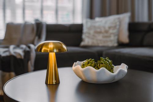 a table with a lamp and a bowl of bananas on it at JW Canmore ApartHouse in Glasgow