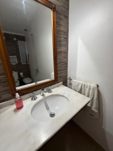 a bathroom with a sink with a large mirror at OLO Hostel Boutique & Bar Club SANTA FE in Santa Fe