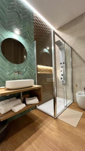 a bathroom with a glass shower and a sink at La Pennichella Vista Veneto in Agropoli