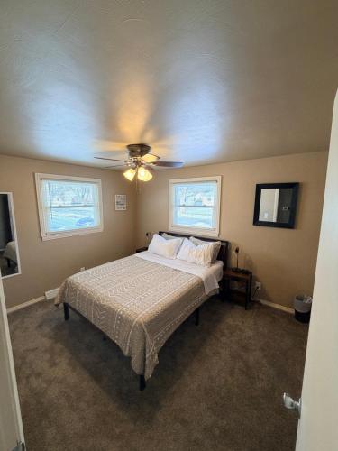 a bedroom with a bed and a ceiling fan at Blended Nest in Green Bay