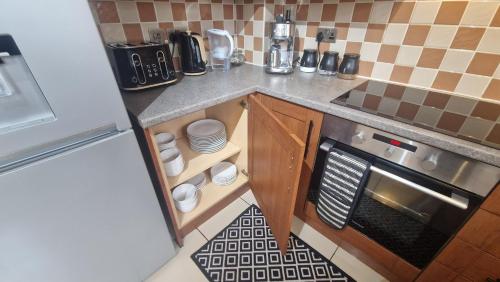 a small kitchen with a counter and a stove at 3-Bedroom Family Holiday Home in Skegness