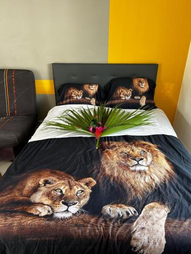 two lions laying on top of a bed at Gwada dream in Saint-François