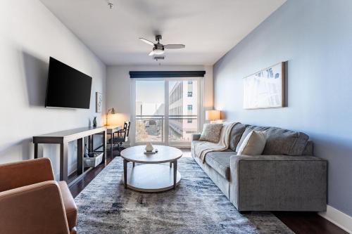 a living room with a couch and a table at Landing Modern 1BD Rooftop Lounge Gym in Orlando