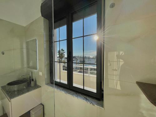 a bathroom with a window with a view of the city at Villa Safira in Durrës