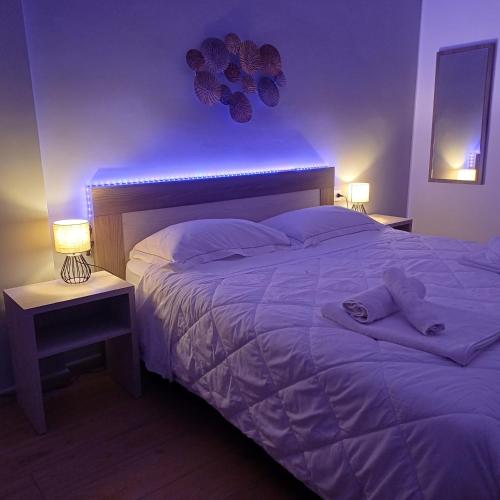 a bedroom with a large bed with purple lighting at Luxury Rooms Bari in Bari