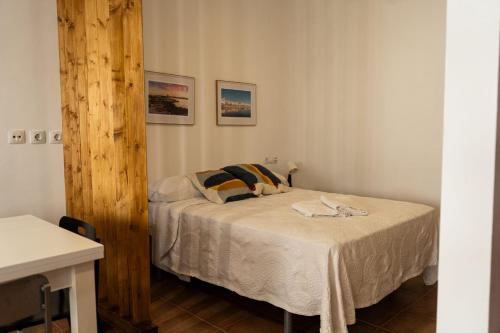a bedroom with a bed with two pillows at Luz del Guadiana in Ayamonte