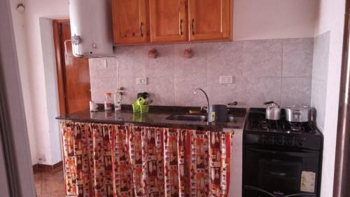 a kitchen with a stove and a counter top at casitadearminda-II in Villa Las Rosas
