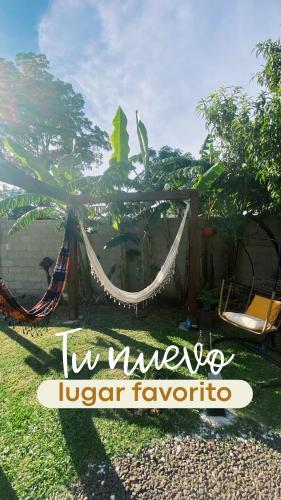 a hammock in a yard with a sign that reads la villa liger at La Posada de Sofi in Concordia