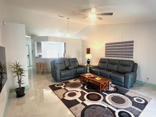 a living room with two couches and a table at Joel's Place in Lake Wales