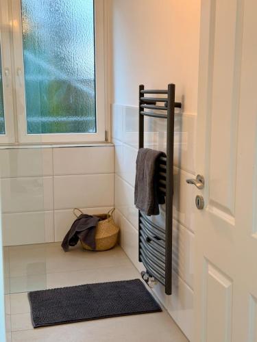 a bathroom with a towel rack next to a door at Modern, bright apartment for individuals & groups in Remscheid