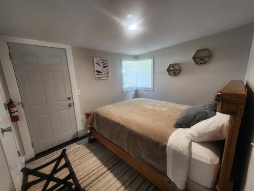 a bedroom with a large bed and a window at Less is Moore in Thompsonville