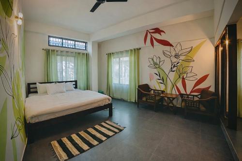 a bedroom with a bed and a painting on the wall at White Lotus in North Lakhimpur