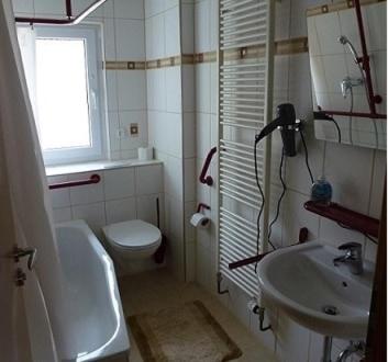 a bathroom with a sink and a toilet and a window at Ferienwohnung Neifer in Bad Überkingen