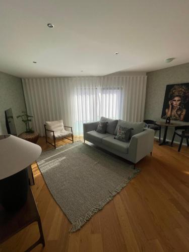 a living room with a couch and a rug at Carreira Residence in Funchal