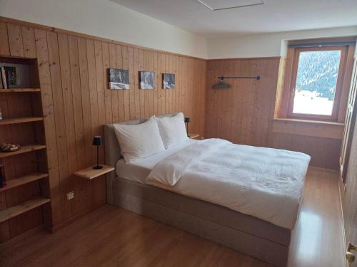 a bedroom with a large bed and a window at Chasa Bellavista in Ardez
