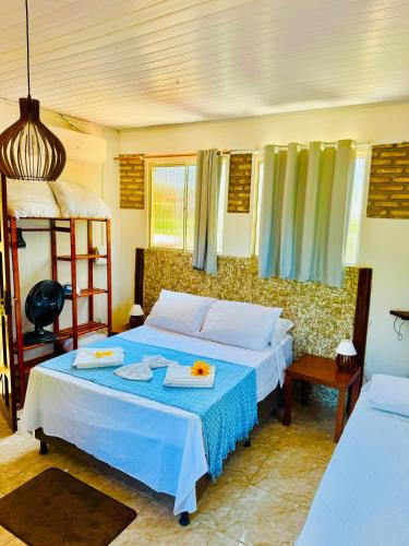 a bedroom with two beds and a bunk bed at Casa Adriê in Itacaré