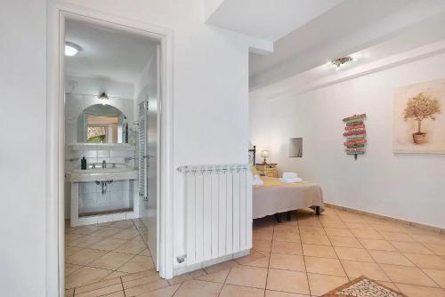 a white bathroom with a sink and a table at Agriturismo Le Pale in Bogliasco