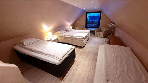 two beds in a small room with a tv at Wallander's hometown, close to beach & café in Ystad