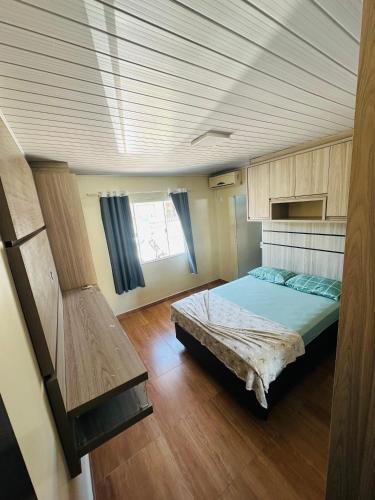 a bedroom with a bed in the middle of a room at casapraia penha sc in Penha